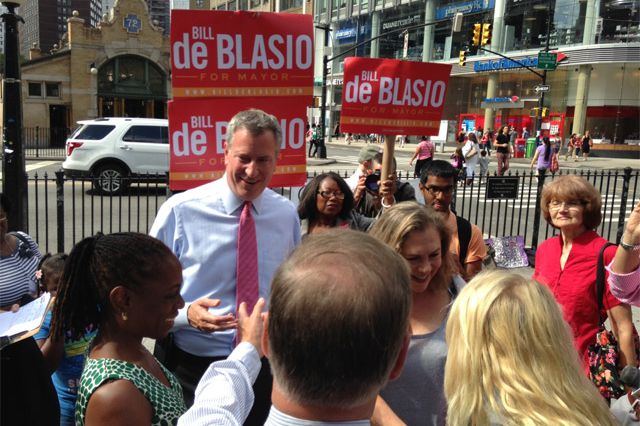 Public Advocate de Blasio on the Upper West Side yesterday—his wife Chirlane McCray is on the left and on the right is actress Kathleen Turner. And the guy, with his back turned and gesturing, in the foreground? Former Vermont Governor Howard Dean.